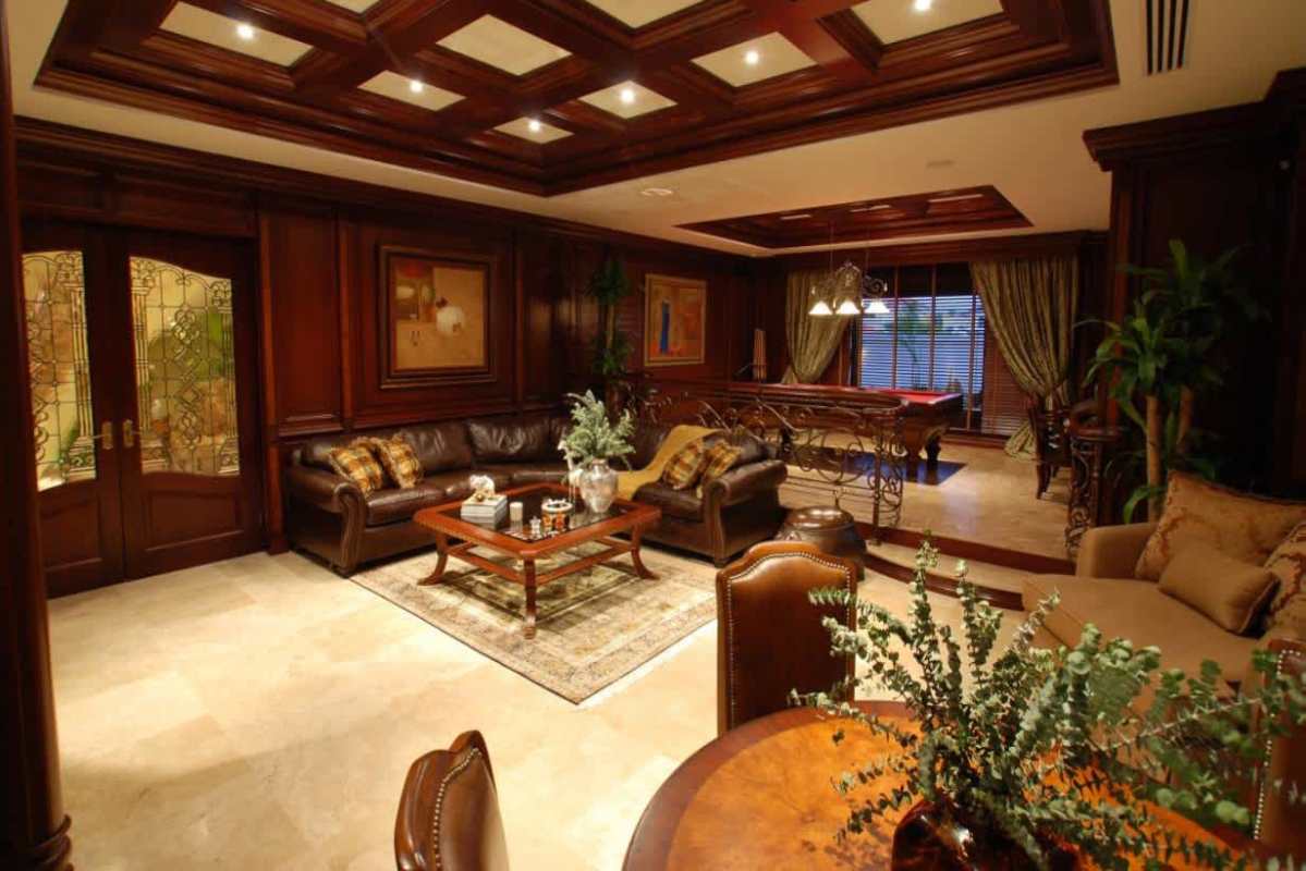 Large chef kitchen with custom wood cabinets, granite countertops, double ovens, and island Costa del Este mansion Panama