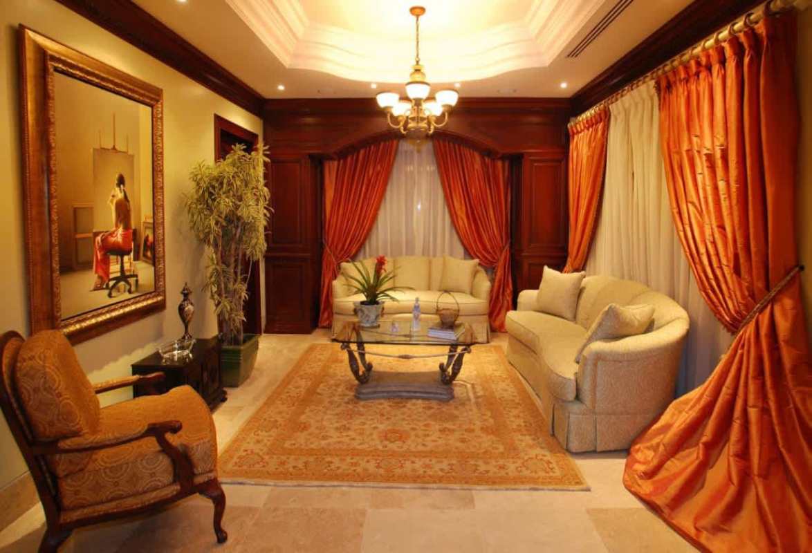 Spacious formal living area with marble floors, large windows, and fine furnishings in luxury house Costa del Este Panama