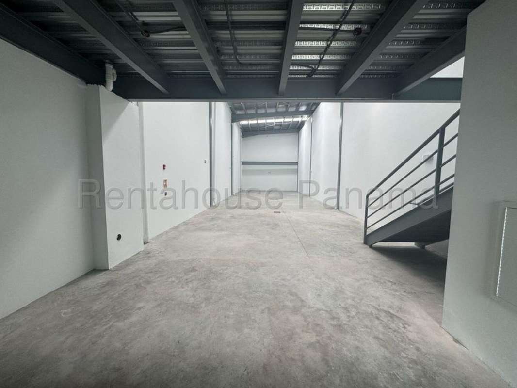 Empty commercial warehouse with high ceiling, industrial lighting and concrete floors in Panama City