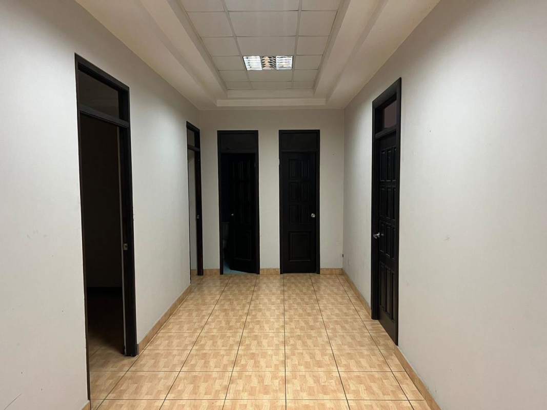 Two-story office warehouse blue building with fenced parking in Panama