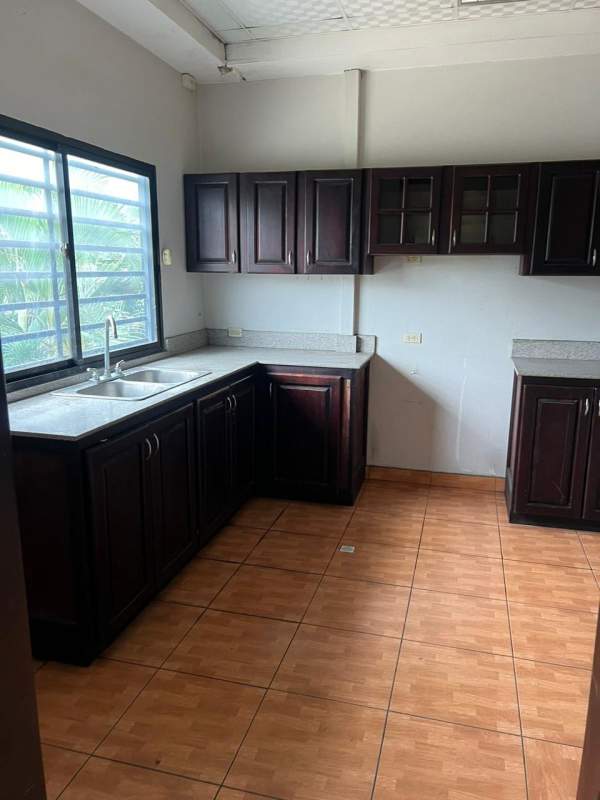 Traditional tiled bathroom with pedestal sink and mirror commercial office building Panama