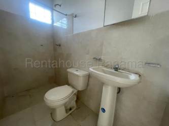 One bathroom with tile, pedestal sink and window in budget house La Chorrera Panama