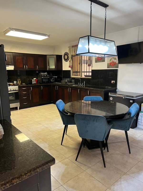 Bar corner with accent stone wall, mounted TV and bar stools PH Paseo Dorado Condado del Rey Panama