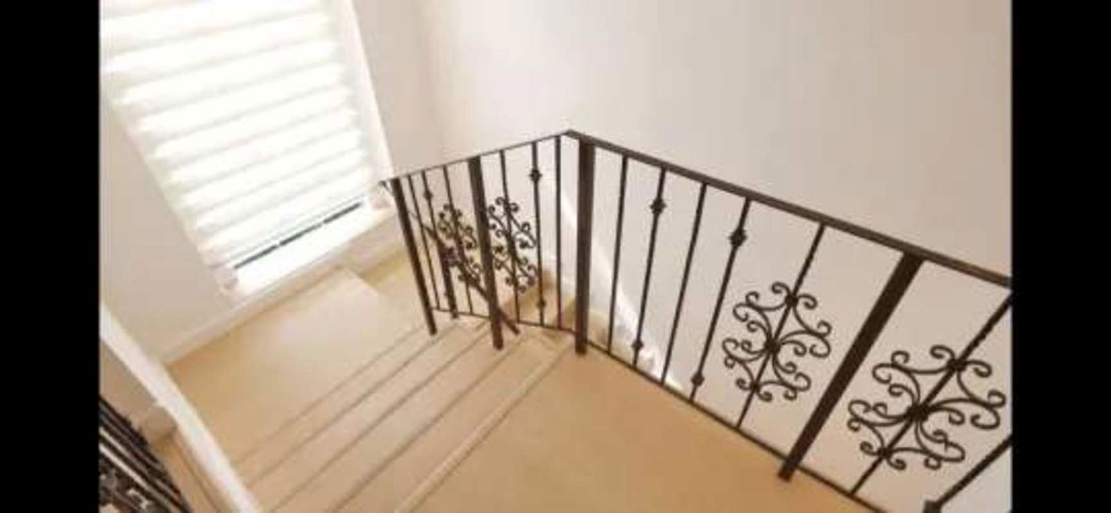 Spacious kitchen with granite countertop, light wood cabinets, large window in Clayton house Panama