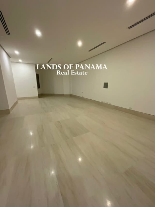 Large contemporary living room with polished marble flooring and floor-to-ceiling windows overlooking Pacific Ocean in Ocean Reef Islands Panama