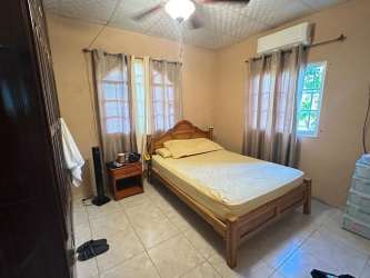 Bedroom with tile floor, AC unit, ceiling fan traditional style Los Santos Panama