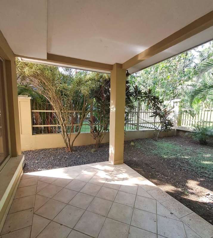 Fenced backyard garden with tropical plants in Embassy Club Clayton Panama