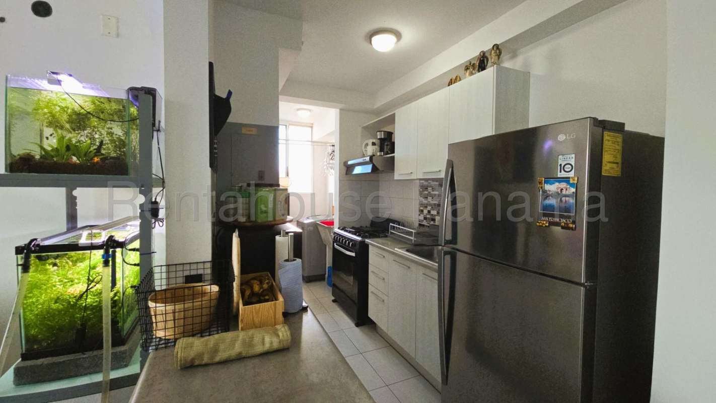 Living room with natural light, sliding glass door opening to private balcony in PH Ilo apartment Juan Díaz Panama