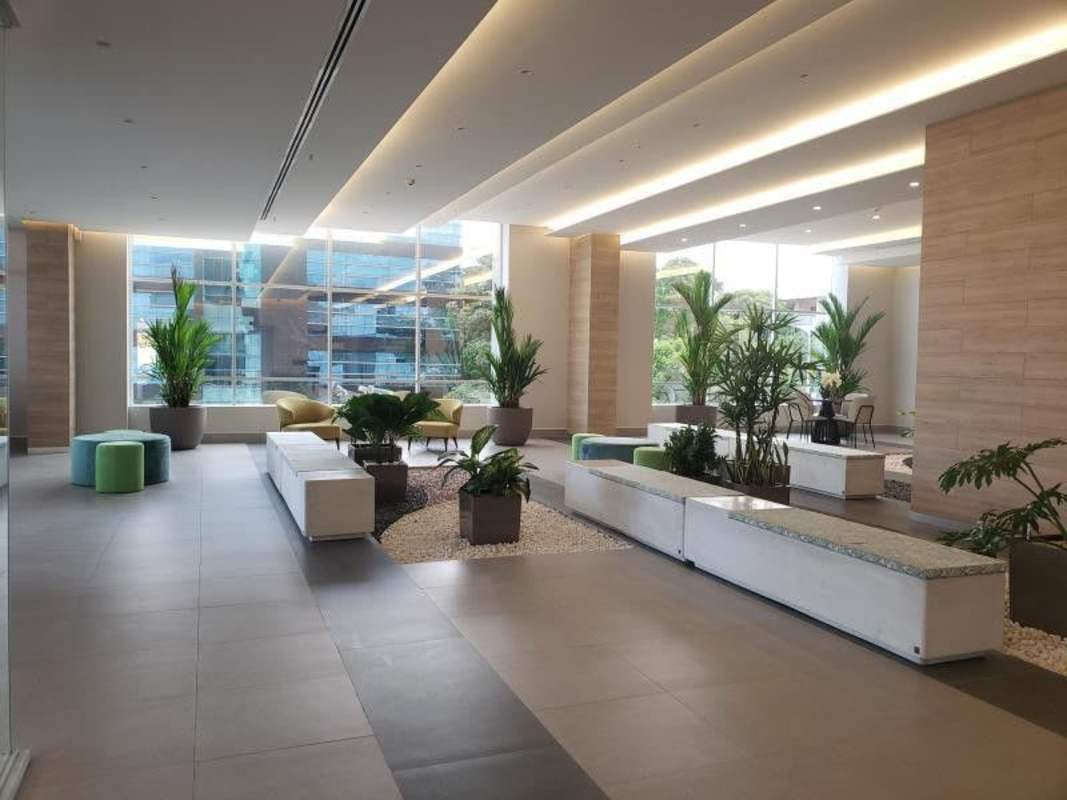 Double-height lobby with indoor plants and modern seating in Vivendi Green Edison Park Panama