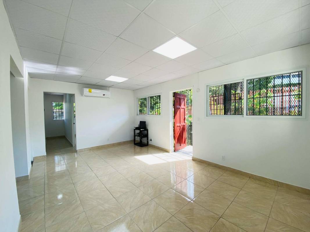 Empty bright office room with tile floors and window security bars near Panama Supreme Court