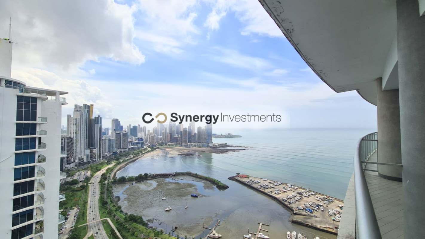 Spacious living dining area with panoramic windows ocean skyline view Yacht Club Tower Panama City