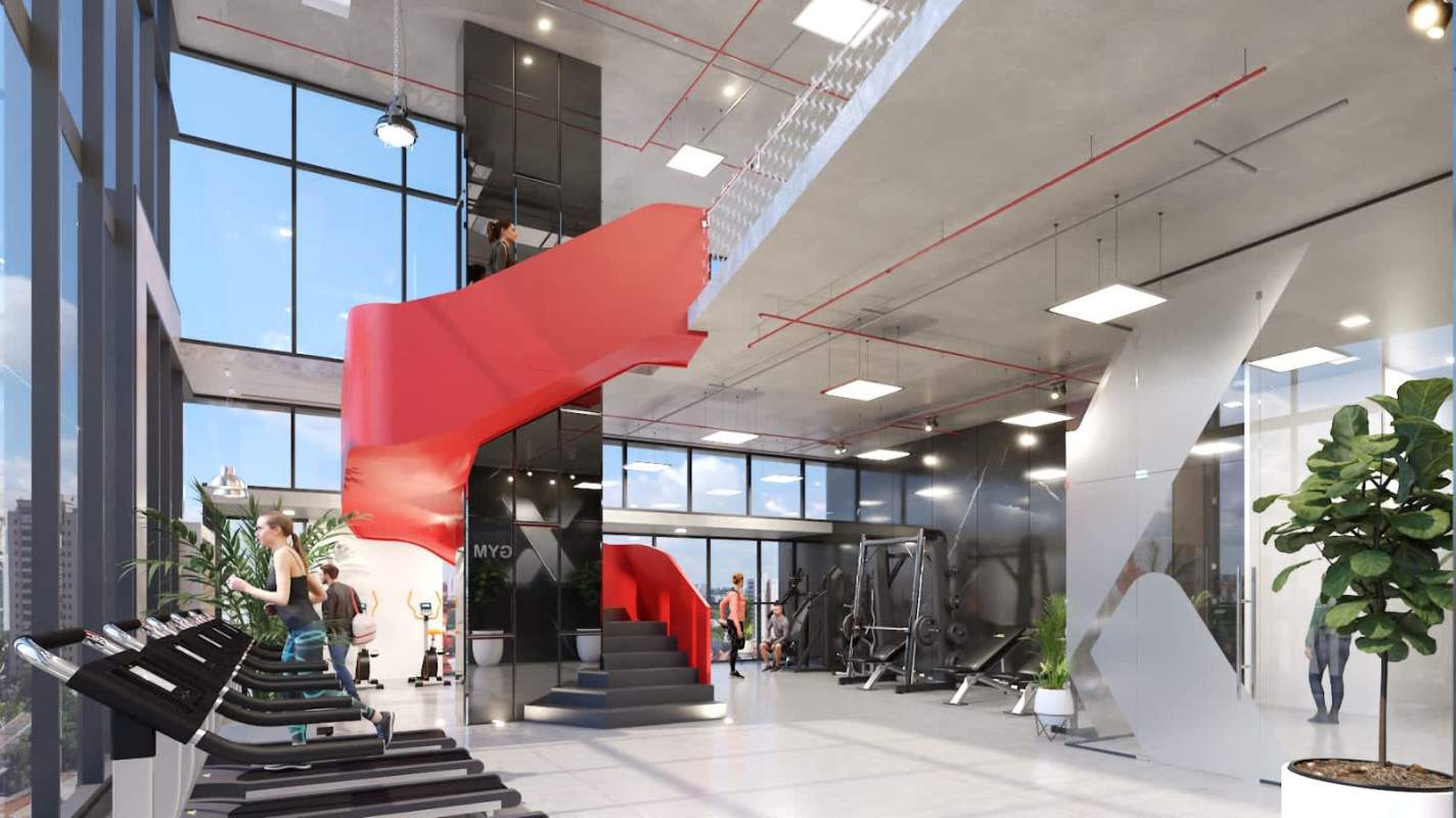 Modern industrial style gym with equipment, red staircase and large windows at PH X The Building