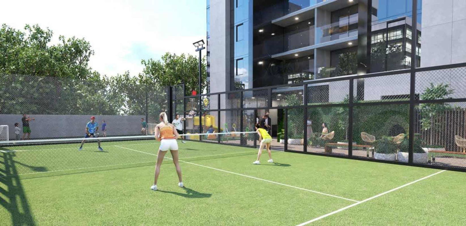 Fenced paddle tennis court beside modern tower PH X The Building San Francisco Panama