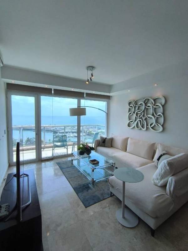 Modern living room with panoramic windows, marble floors and ocean views in Avenida Balboa Panama