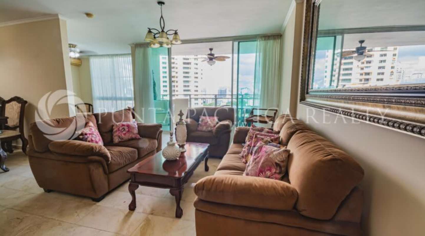 Bright living room with large windows leading to terrace in Costa Pacifica Punta Pacifica Panama