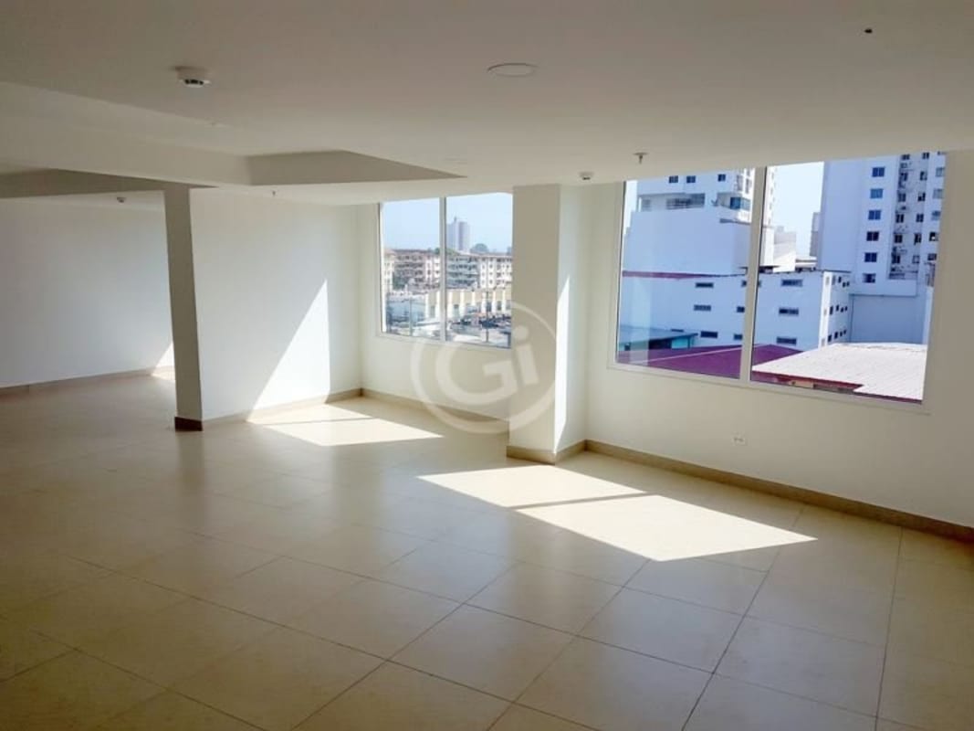 Kitchen with granite countertops, upper cabinets, refrigerator and microwave in furnished apartment PH Taurus Tower Panama City