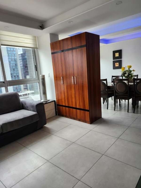 Open plan living dining area with large windows overlooking Panama City skyline Obarrio PH Cristal Park