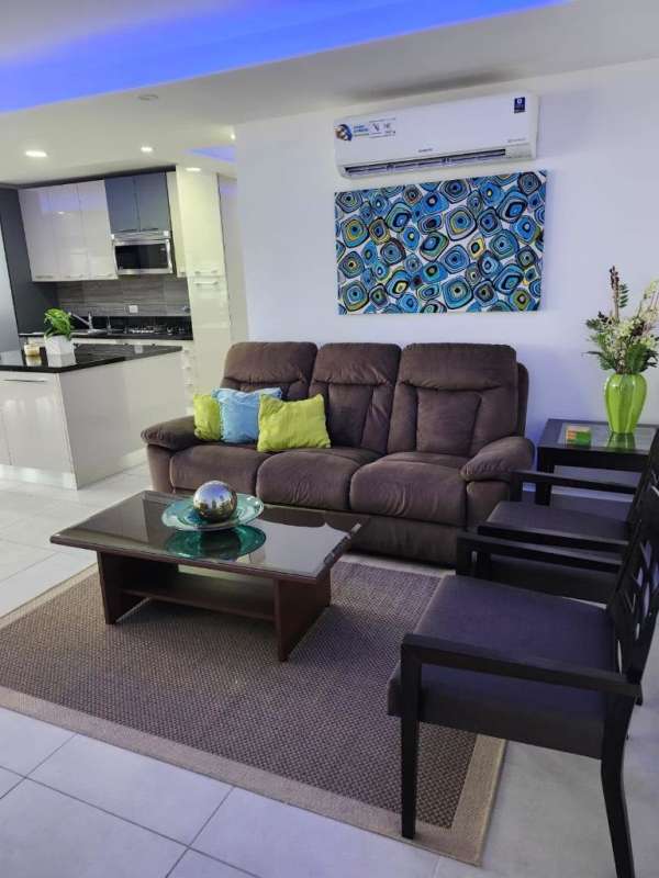 Furnished contemporary living room with art and view to kitchen PH Cristal Park Obarrio Panama
