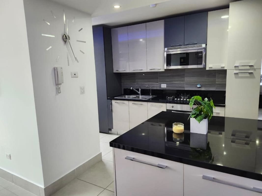 Contemporary kitchen with granite counters, appliances, open to living space PH Cristal Park Panama City