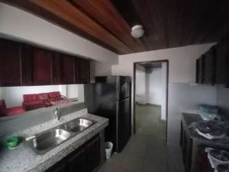 Simple bedroom in Chitré with wooden ceiling, tiled floor, built-in wardrobe, natural light