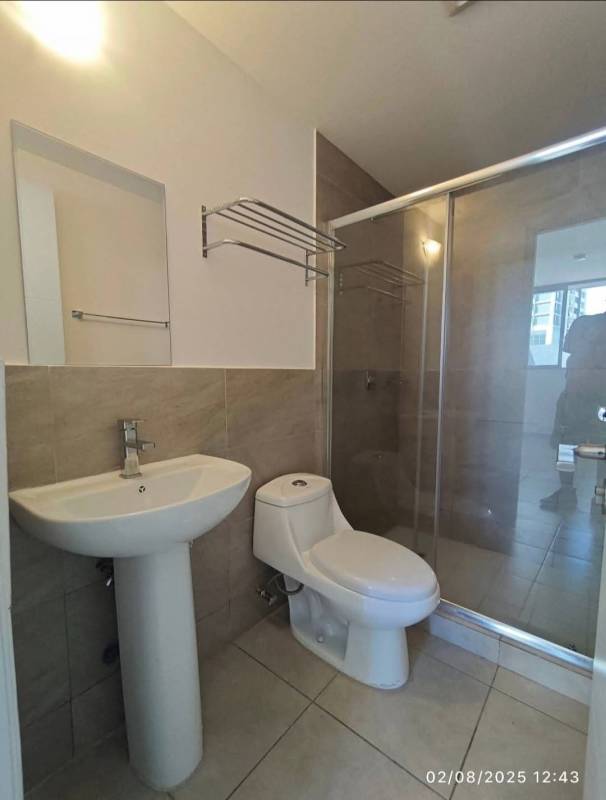 Minimalist bathroom with shower glass door at PH Athas apartment in Villa Lucre Panama