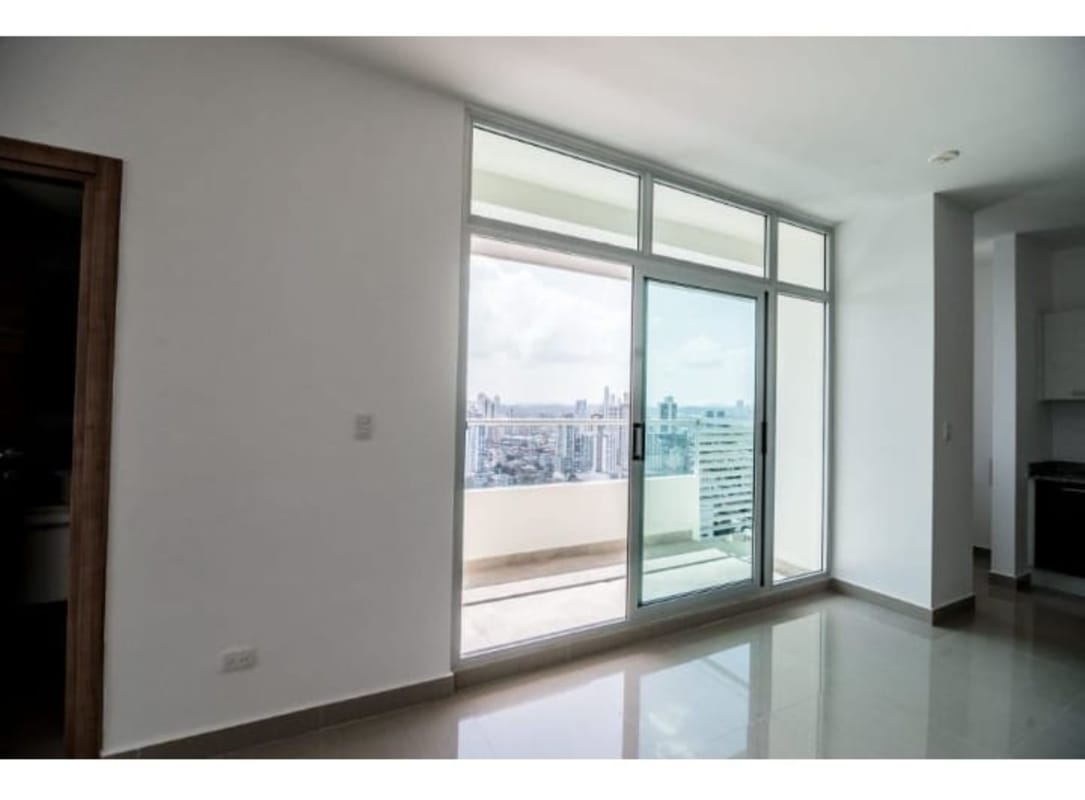 Modern living and dining room with marble flooring and access to balcony at PH Roma San Francisco Panama