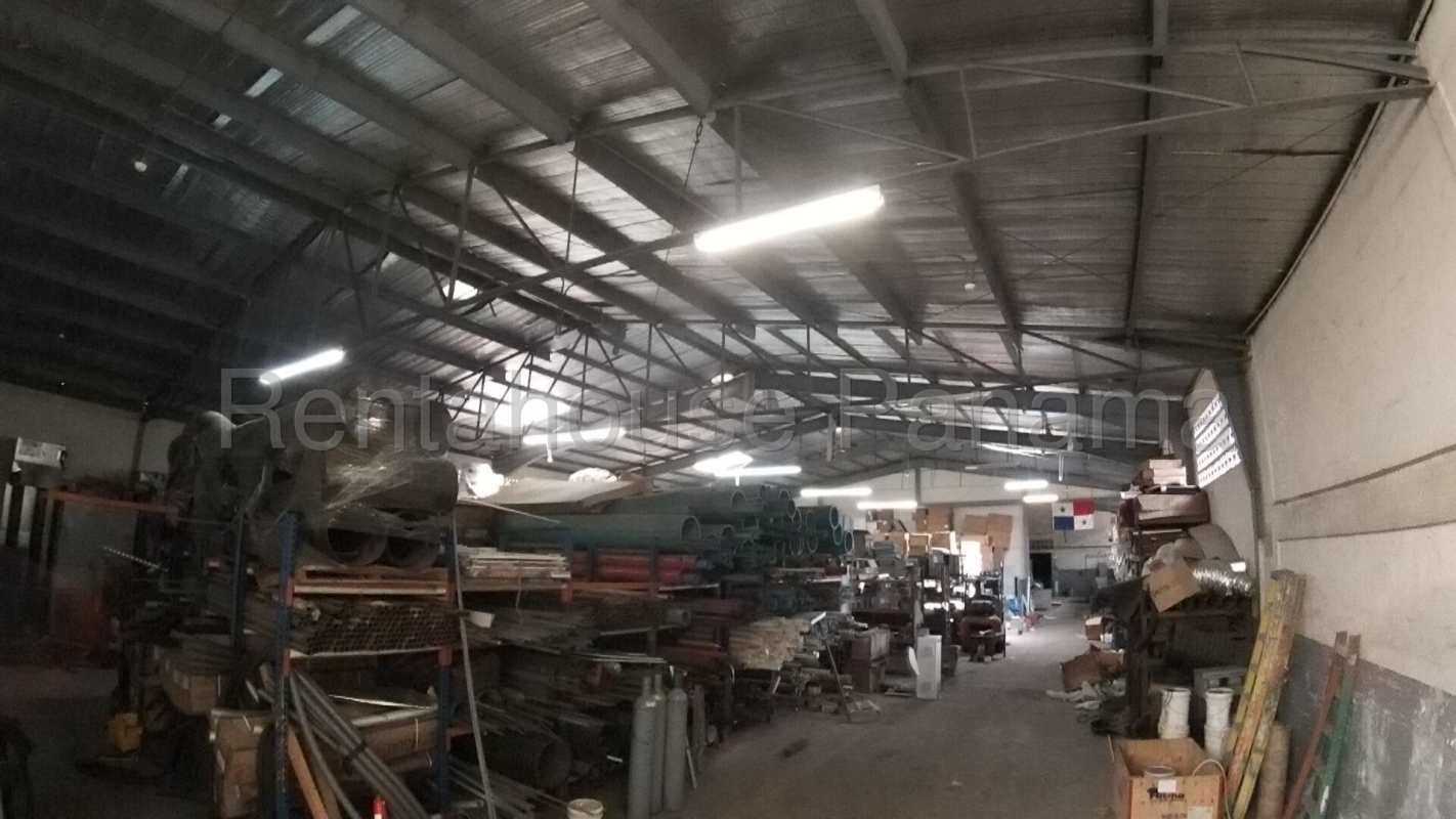 Interior of industrial warehouse with high ceiling and storage racks in Panama City