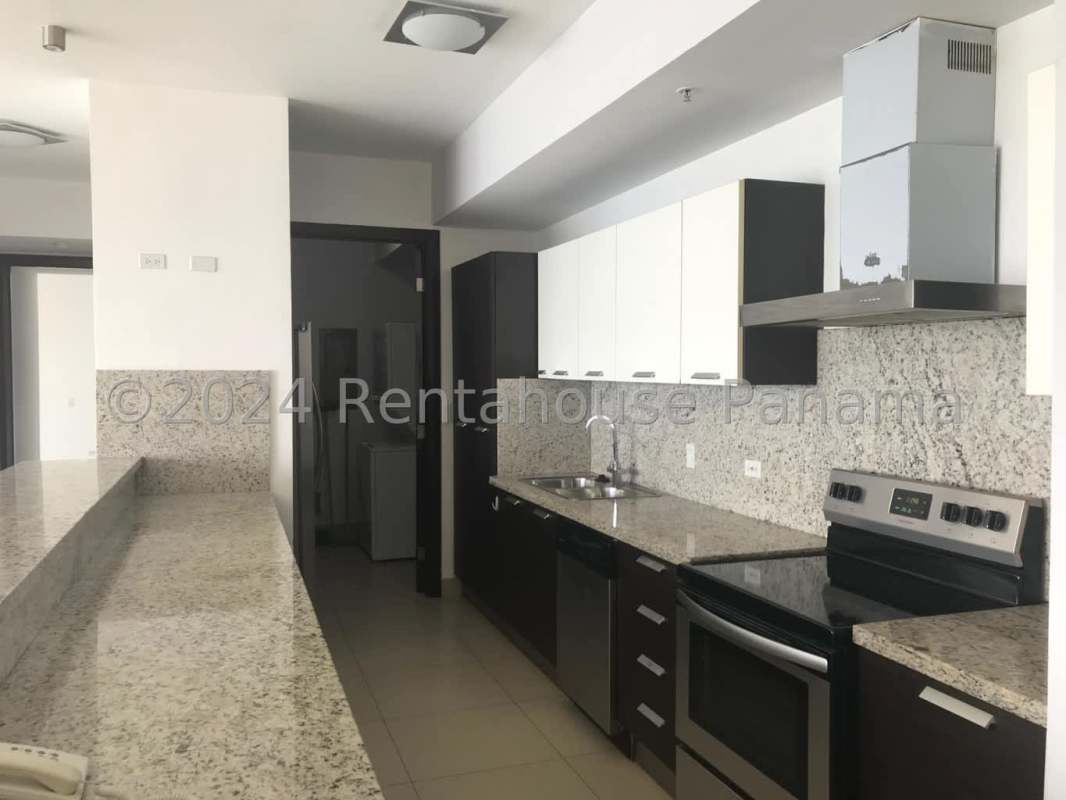 Contemporary kitchen with granite countertops, stainless appliances, and breakfast bar in PH Ocean View Panama City