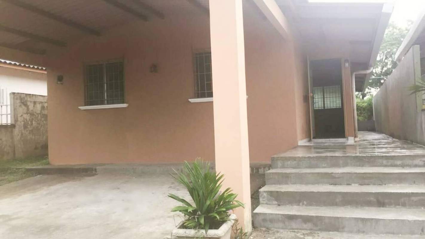 One-story house with beige walls, covered porch, paved driveway in San Remo Villa Zaita Panama