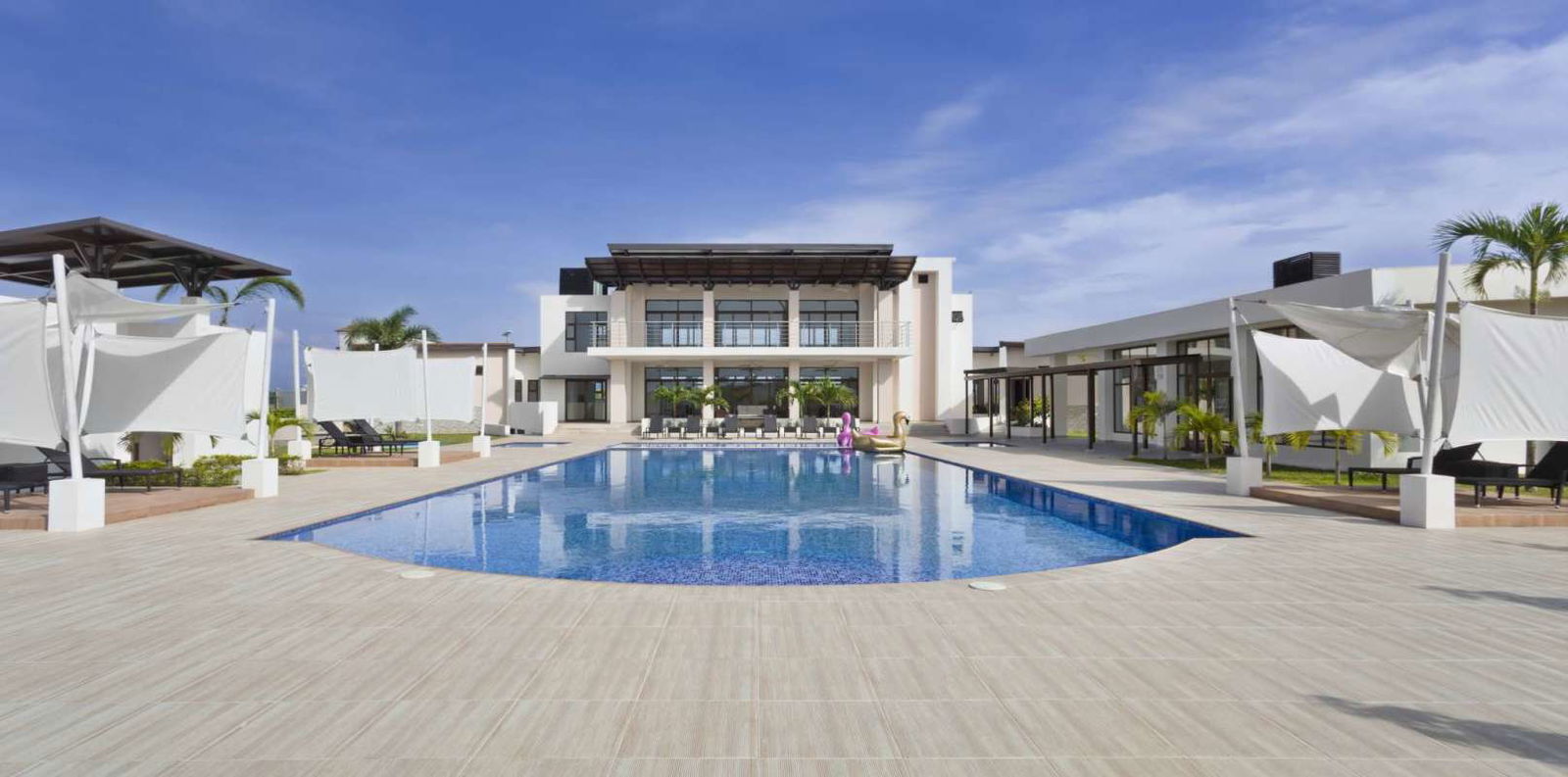 Large swimming pool with cabanas and lounge Costa Sur upscale community