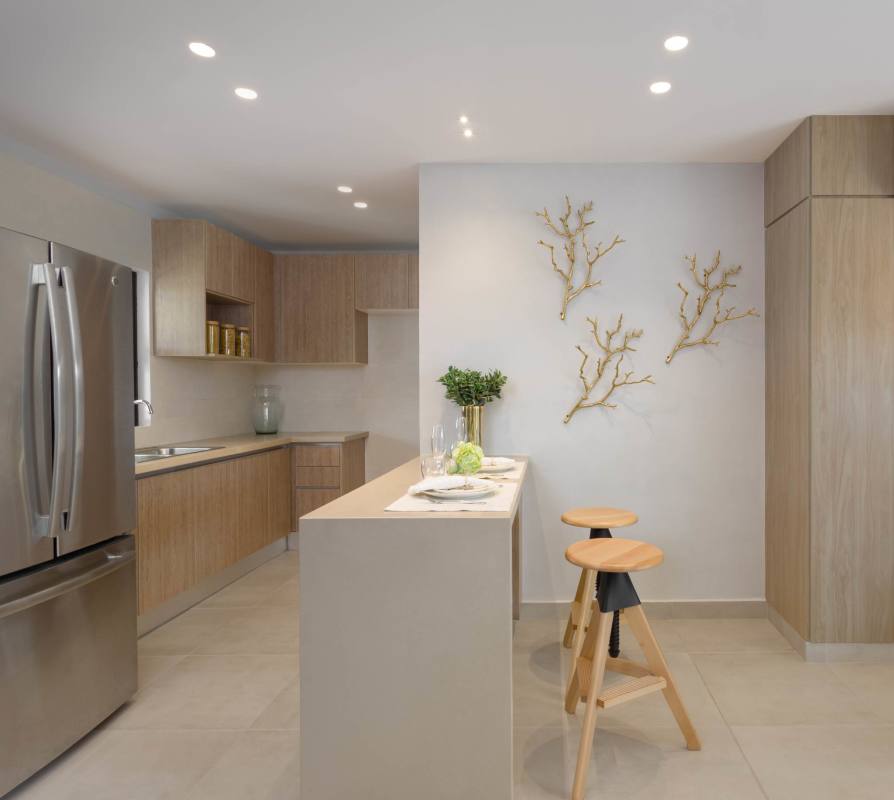 Minimalist kitchen with wooden cabinetry and breakfast bar Costa Sur Panama