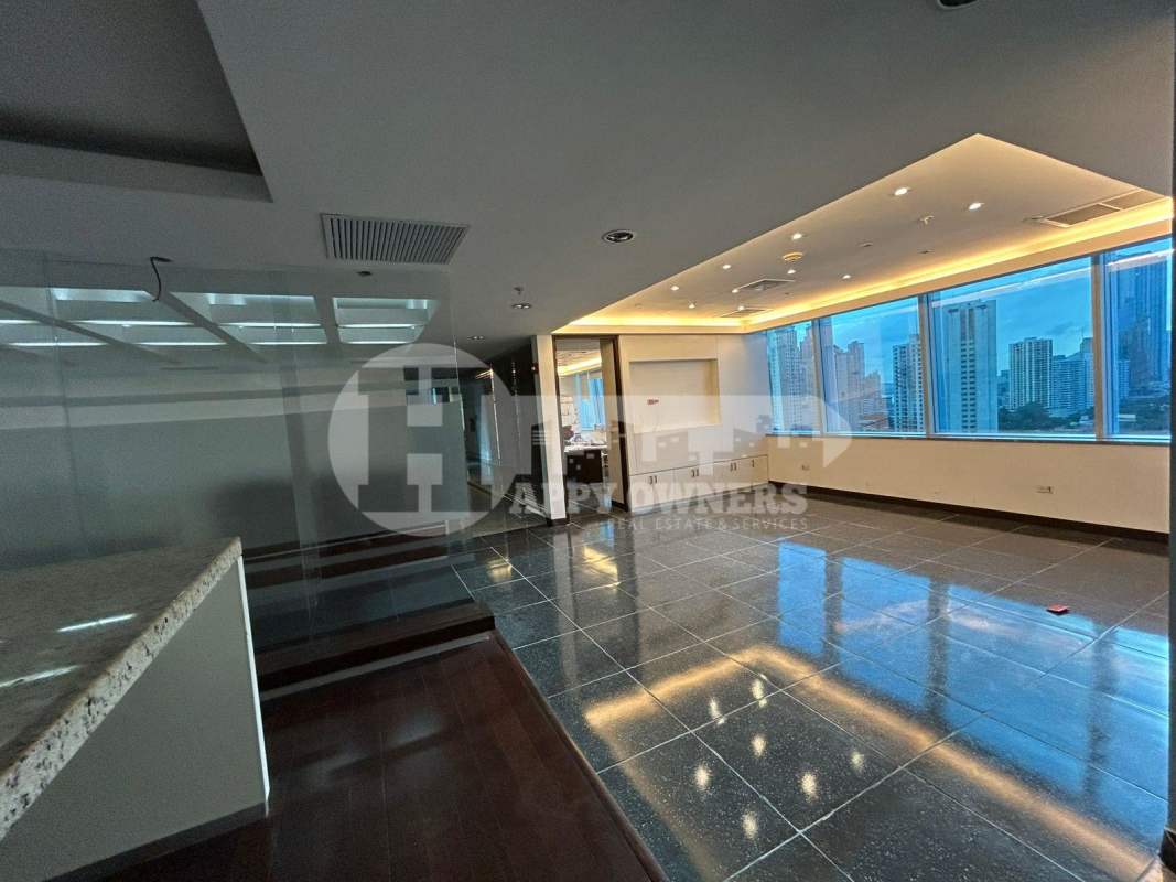 Bright open-plan office with floor to ceiling windows city skyline view in Torre de Las Americas Panama City