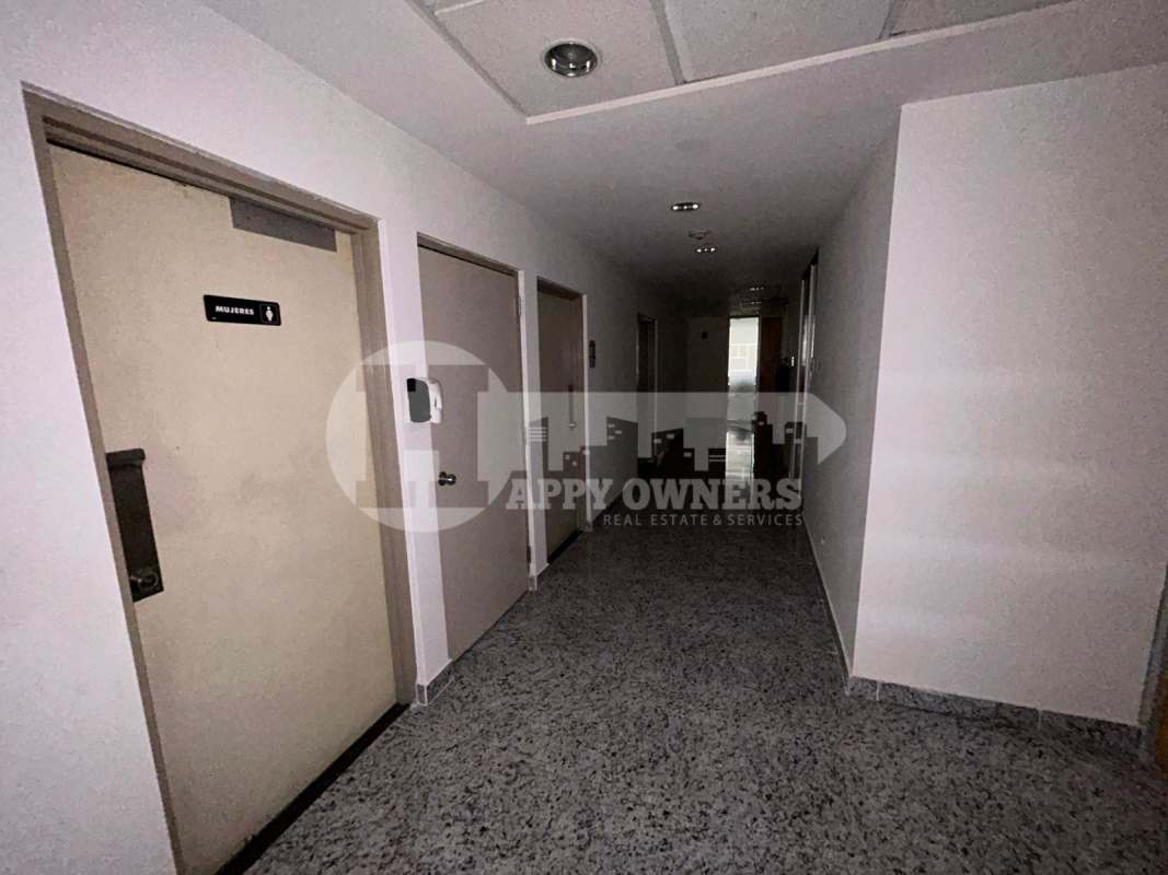 Wide entrance corridor with granite floors and multiple doors premium office floor Torre Las Americas Panama