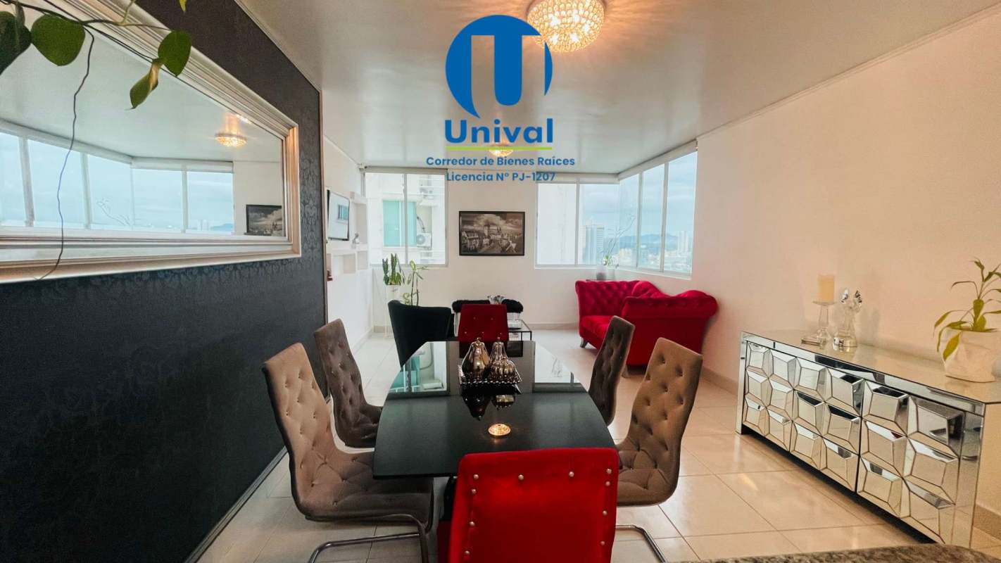 Modern dining and living space with red accents, city view windows at Plaza Edison Panama