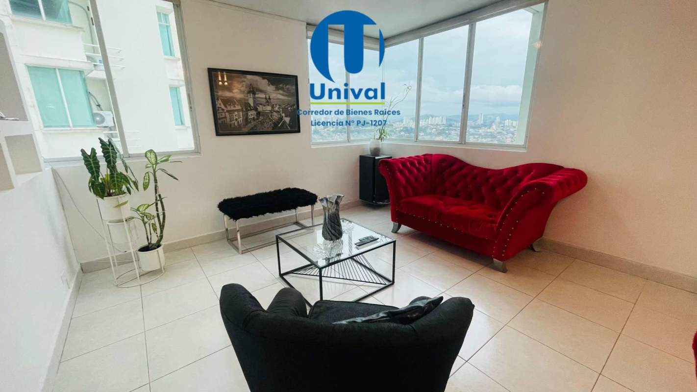 Living area with large windows, red sofa, modern decor, city view at PH Vivendi Plaza Edison