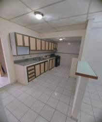 Simple living area with tiled floors and arch partition in budget home Arraiján Panama