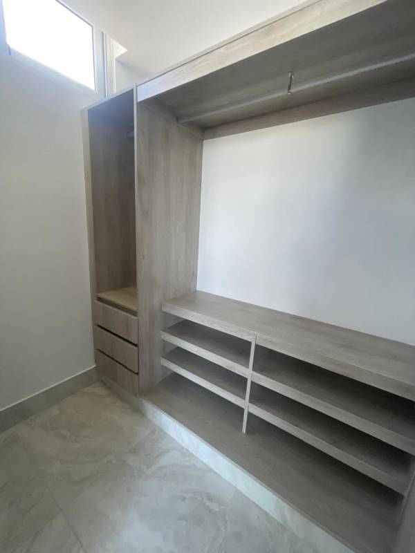 Modern bedroom with large window, built-in closet panoramic city views PH Luxor Panama