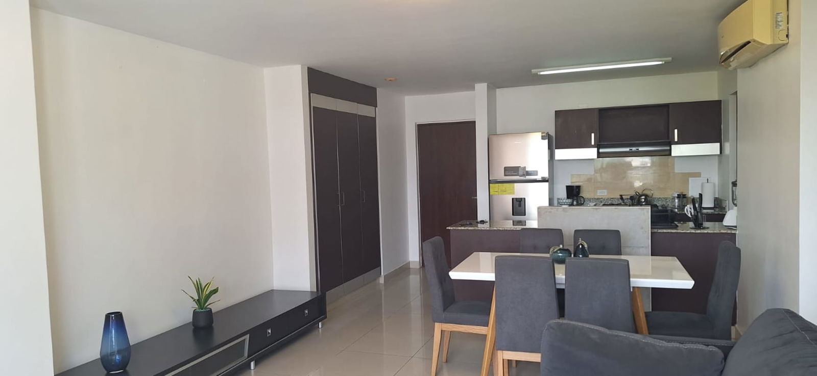 Modern bedroom with large windows blinds city skyline view at PH Bali Costa del Este