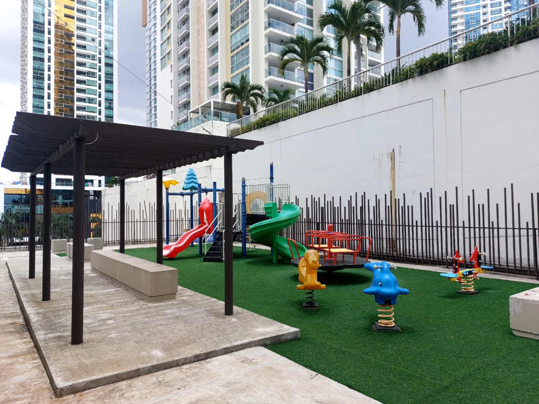 Outdoor playground area multi-colored slides shaded sitting at PH Bali Costa del Este