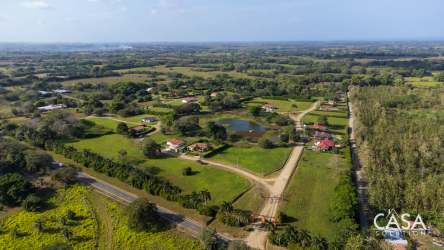 Aerial view of Equus Village rural estate with green fields and houses Pedasi Panama