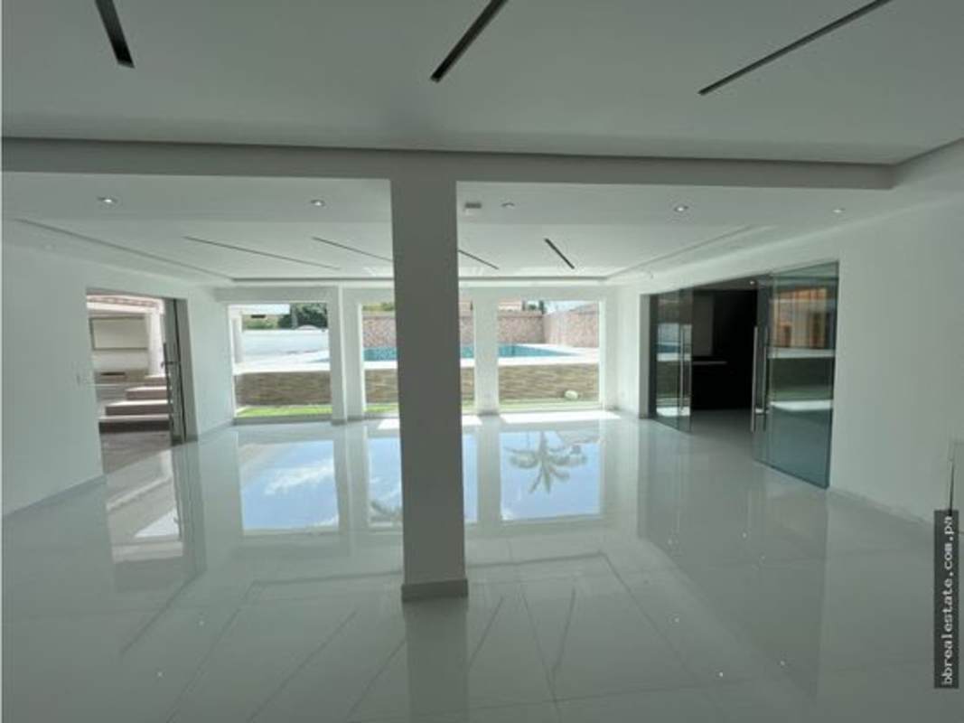 Modern custom-built home theater with recliners and LED lighting in Costa del Este