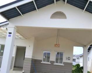 Gated community street surrounded by palm trees and family houses Playa Dorada Panama