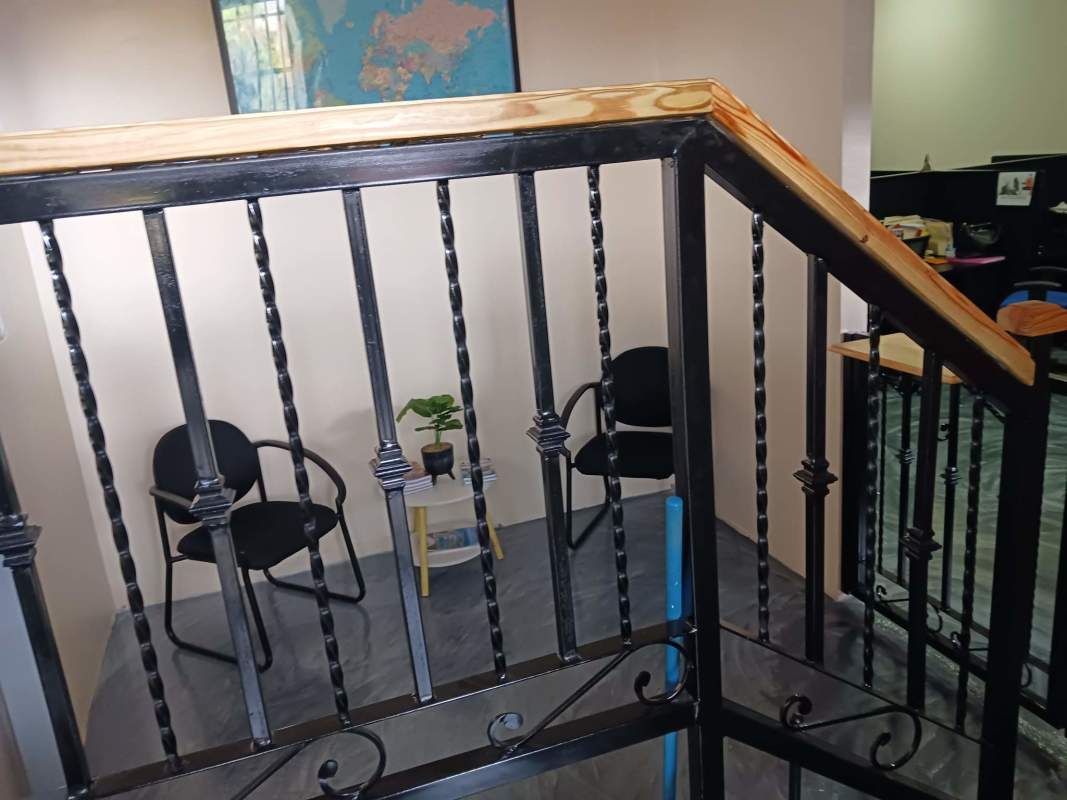 Interior stairway landing with chairs and world map decor commercial property Betania Panama.