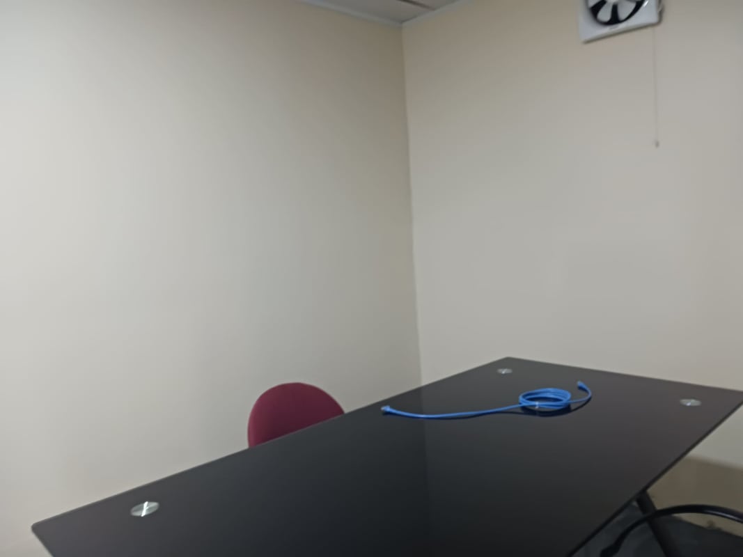 Multiple workstation cubicles inside office space in Betania with beige walls.