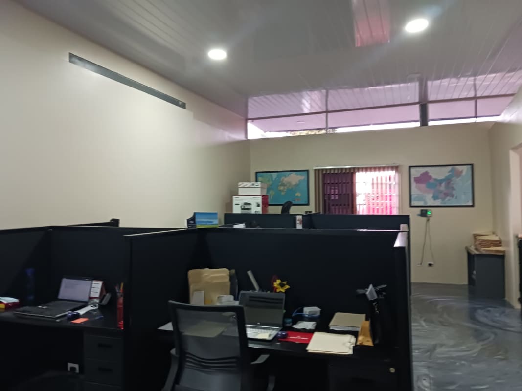 Small office room featuring air conditioning split unit and sliding windows with lock bars.