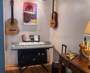 Contemporary kitchen with wood cabinets, granite backsplash, and natural light in Altos del Campo