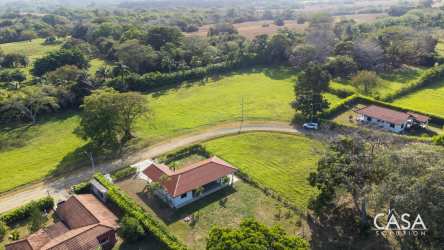Multiple countryside homes around natural pond and green fields Panama Pedasi Equus Village