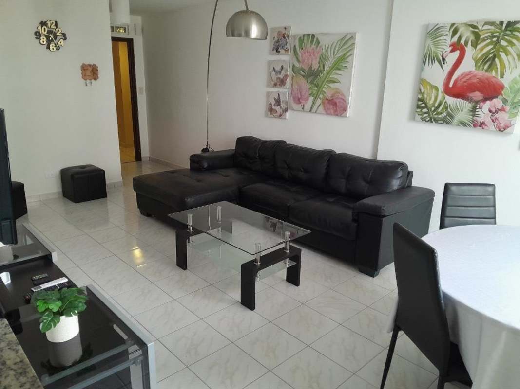 Living dining room with TV, sectional sofa, large windows in PH Ibiza Panama City