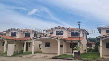 Street view of Mediterranean-style two-level houses with carports La Chorrera Panama