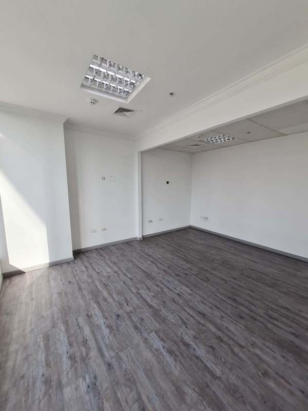 Well-lit office hallway with wood floors and multiple doors PH Ocean Business Plaza Panama